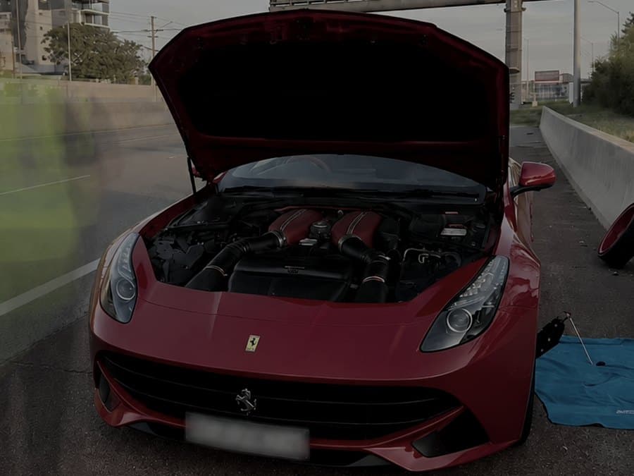 Ferrari F12 with the bonnet open during a battery replacement in Perth